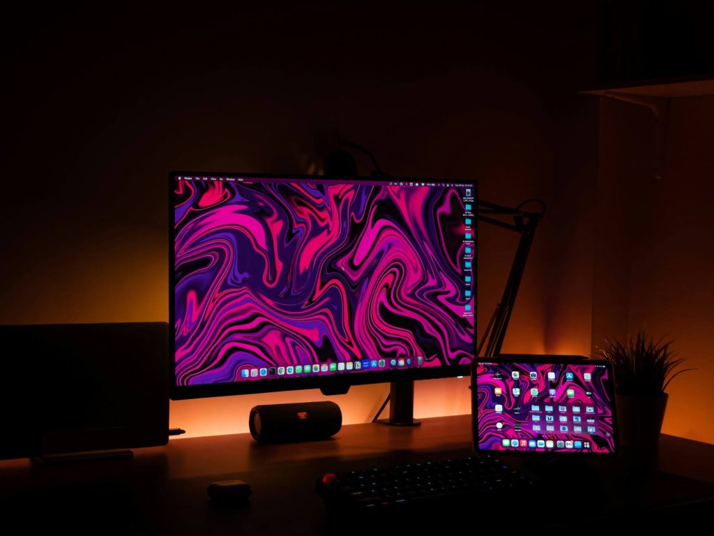 Modern dual-monitor gaming setup with a neon-lit room and a gamer-optimized web browser open
